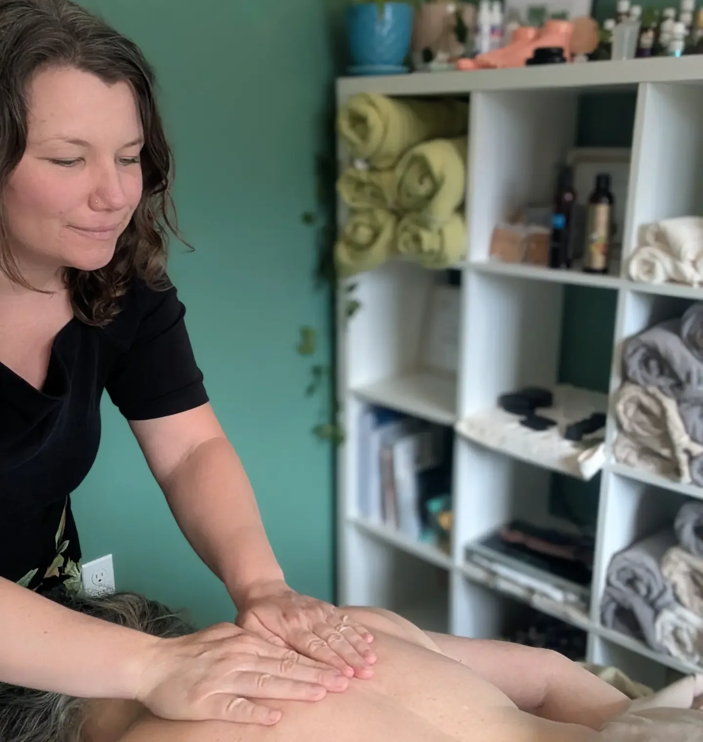 Haley Lorman working on a client’s upper back during a slow, calming session